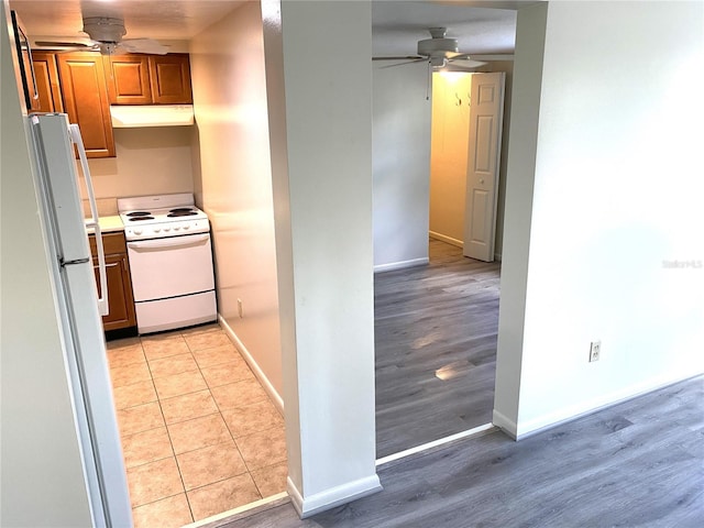 kitchen with light hardwood / wood-style flooring, ceiling fan, and white appliances