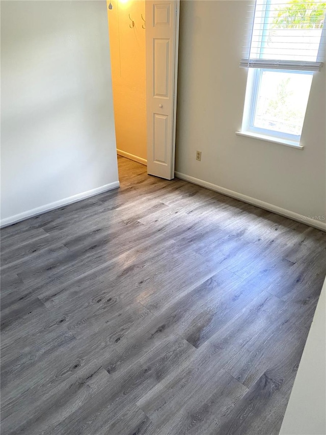 spare room with dark hardwood / wood-style flooring