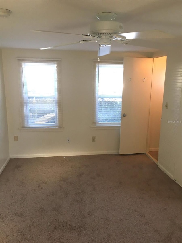 carpeted empty room featuring ceiling fan