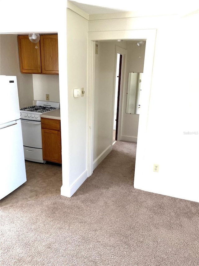 kitchen with light colored carpet and white appliances