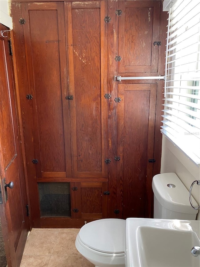 bathroom featuring sink, toilet, and tile patterned floors