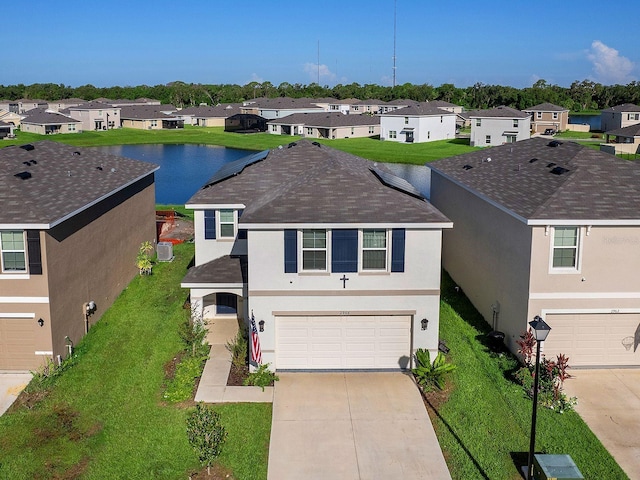 single story home featuring a garage and a water view