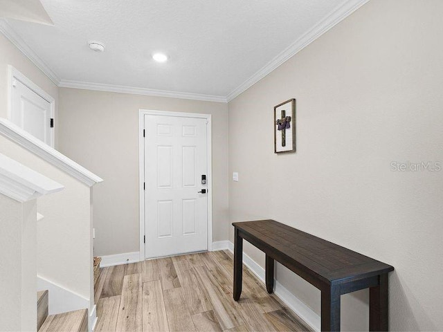 entrance foyer with light wood-type flooring and crown molding