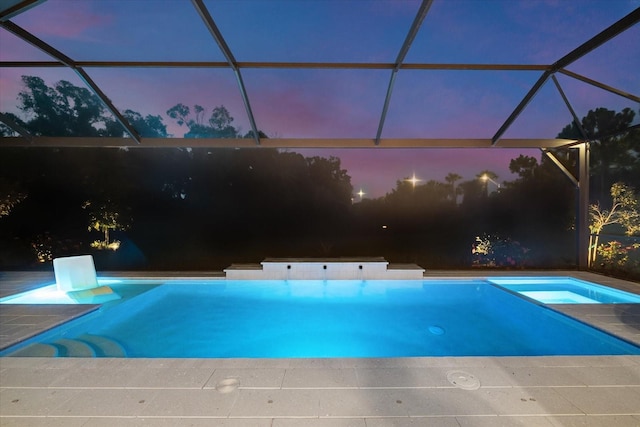 view of swimming pool with a lanai