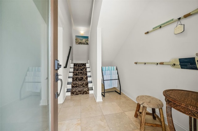 interior space featuring light tile patterned floors and crown molding