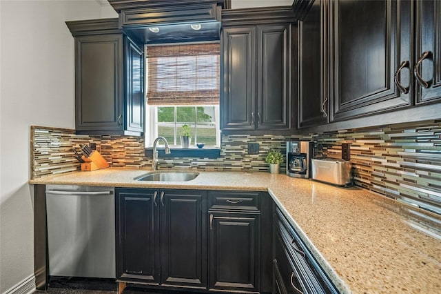 kitchen featuring sink, dishwasher, light stone countertops, and tasteful backsplash