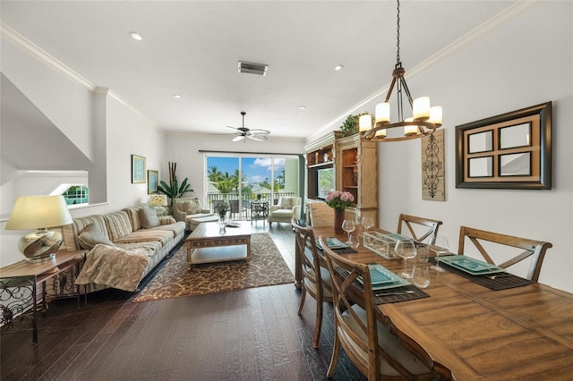 dining space featuring dark wood-type flooring, crown molding, and ceiling fan with notable chandelier