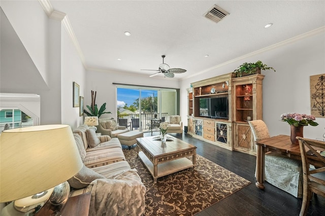 living room with dark hardwood / wood-style floors, crown molding, and ceiling fan