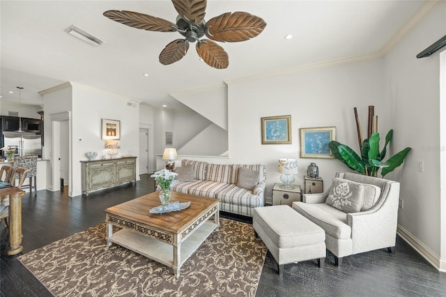 living room with dark hardwood / wood-style floors, ceiling fan, and ornamental molding