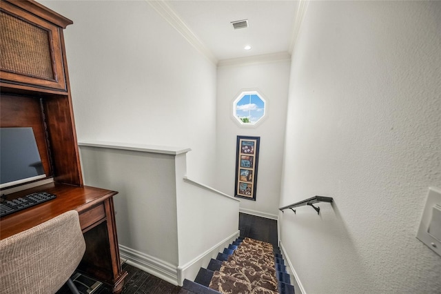 stairs featuring crown molding and dark wood-type flooring