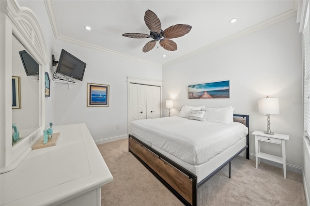 carpeted bedroom featuring a closet, ceiling fan, and crown molding