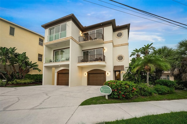 view of front of property with a balcony and a garage