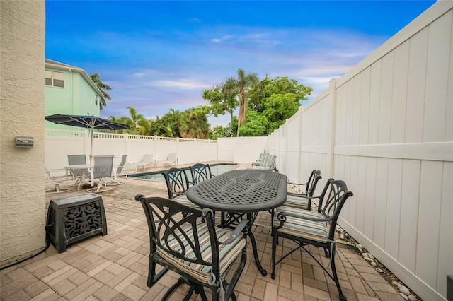 view of patio / terrace with a fenced in pool