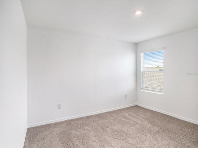 unfurnished room featuring carpet