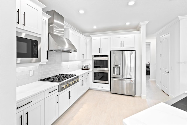 kitchen featuring crown molding, stainless steel appliances, light countertops, decorative backsplash, and wall chimney exhaust hood