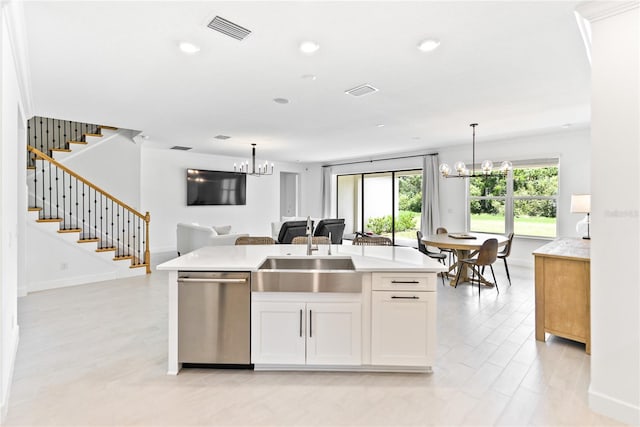 kitchen featuring white cabinetry, dishwasher, an island with sink, and sink