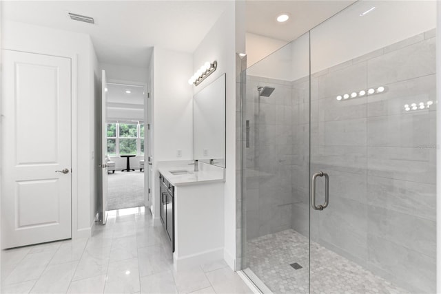 full bathroom featuring a shower stall, visible vents, baseboards, and vanity