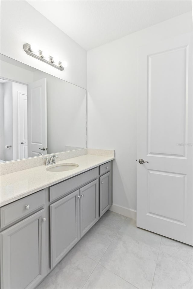 bathroom with vanity and baseboards