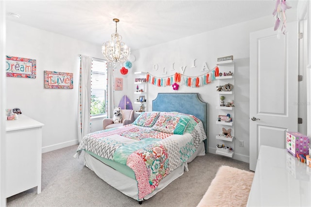 carpeted bedroom featuring a notable chandelier and baseboards