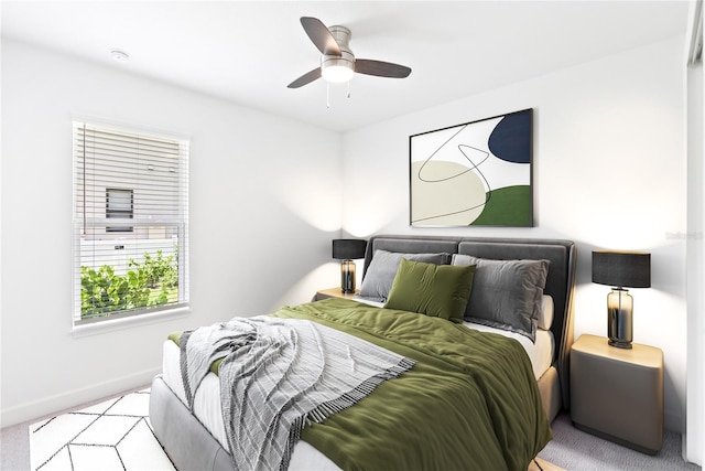 bedroom with carpet, a ceiling fan, and baseboards