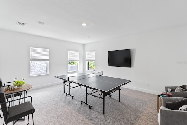 recreation room with light colored carpet