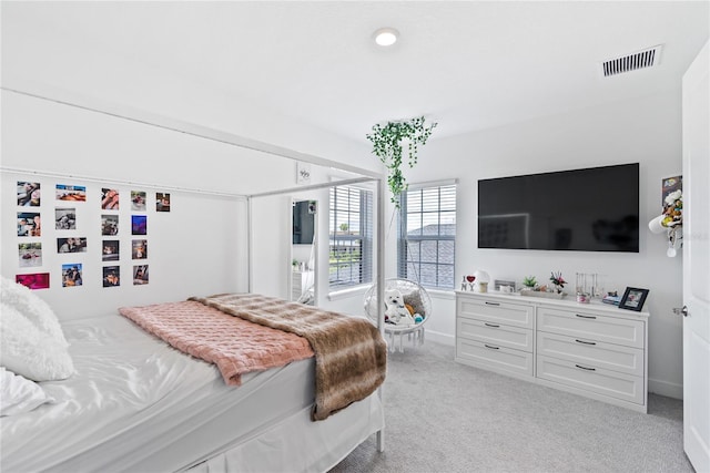 bedroom with light carpet and visible vents