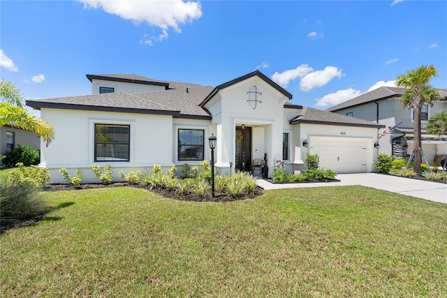 view of front of home with a front yard, concrete driveway, an attached garage, and stucco siding