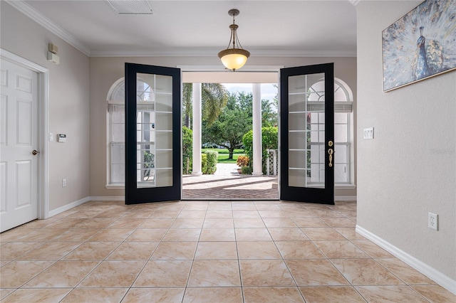 foyer with light tile patterned flooring, crown molding, and french doors