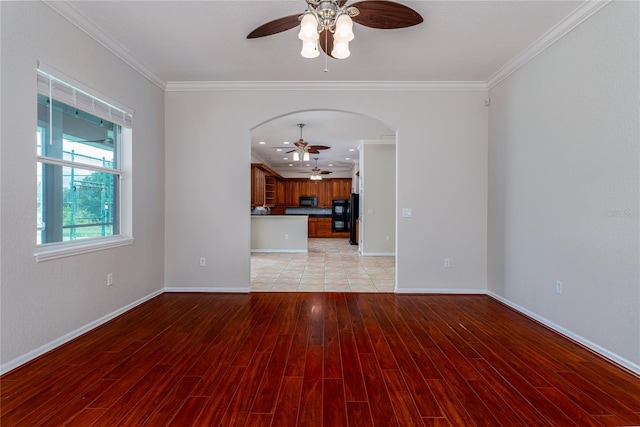 unfurnished living room featuring crown molding, ceiling fan, and light tile patterned floors