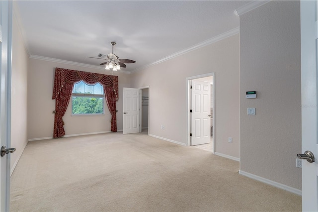 carpeted empty room featuring ornamental molding and ceiling fan