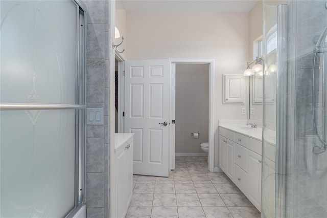 bathroom featuring tile patterned floors, vanity, and toilet