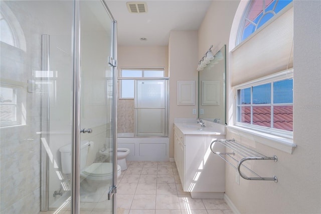 full bathroom with tile patterned flooring, bath / shower combo with glass door, toilet, and vanity