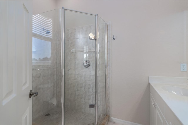 bathroom featuring vanity and an enclosed shower