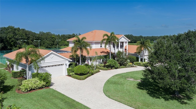 view of front of house featuring a garage and a front lawn