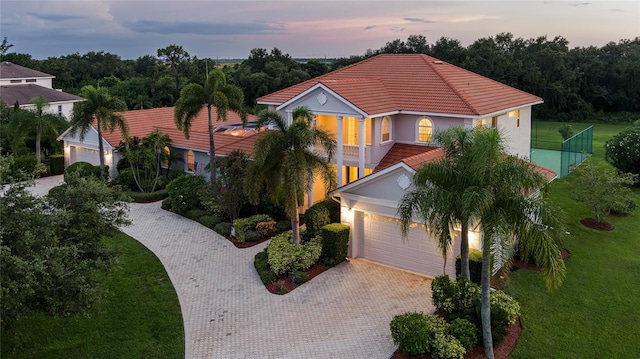 mediterranean / spanish-style house featuring a balcony and a garage