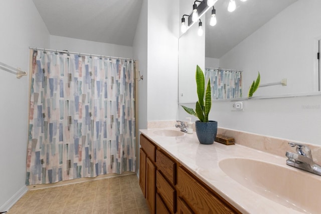 bathroom featuring vanity, vaulted ceiling, and curtained shower