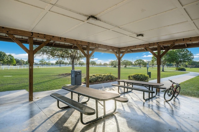 view of community with a lawn and a patio area