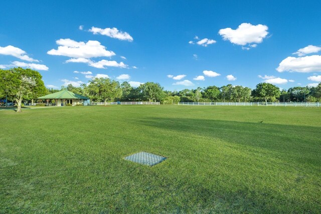 view of home's community featuring a yard and a rural view