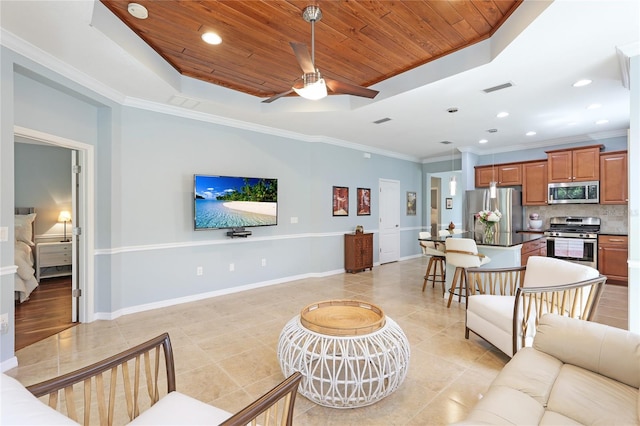 living room with light tile patterned flooring, ornamental molding, ceiling fan, a raised ceiling, and wooden ceiling