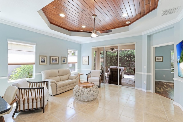 living room featuring a tray ceiling, light tile patterned floors, wood ceiling, and crown molding