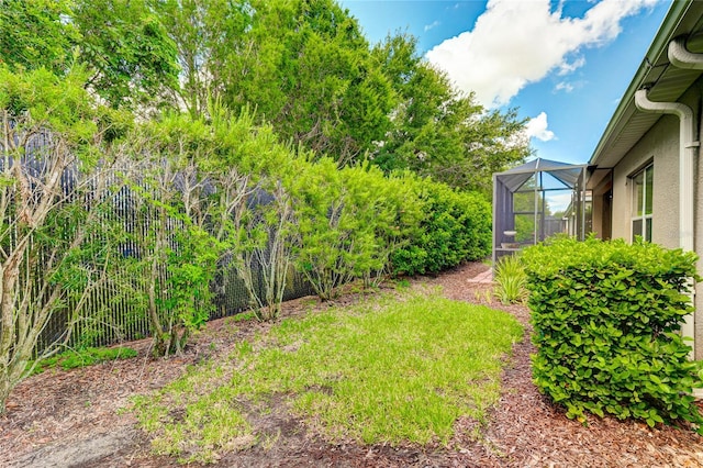 view of yard with glass enclosure