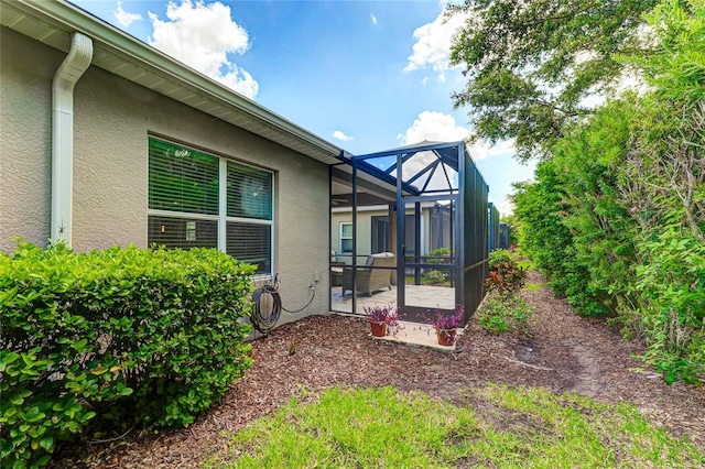 view of yard featuring a patio and a lanai