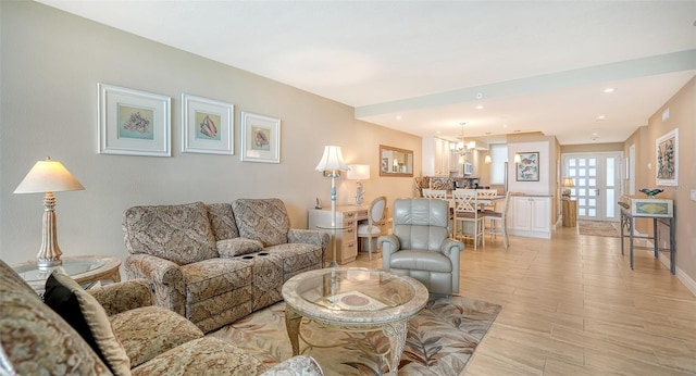 living room with light hardwood / wood-style flooring and an inviting chandelier