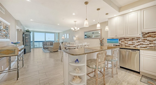 kitchen with tasteful backsplash, white cabinets, an inviting chandelier, decorative light fixtures, and stainless steel dishwasher