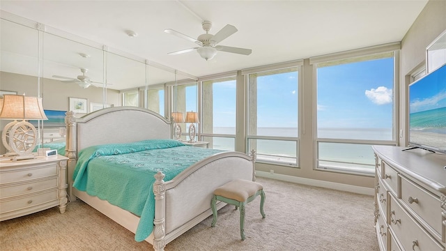 carpeted bedroom with multiple windows and ceiling fan