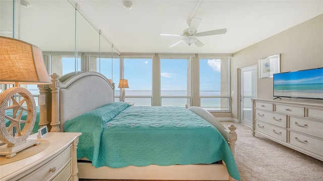 bedroom featuring light carpet, multiple windows, and ceiling fan