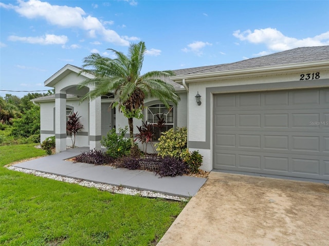 single story home with a garage and a front lawn