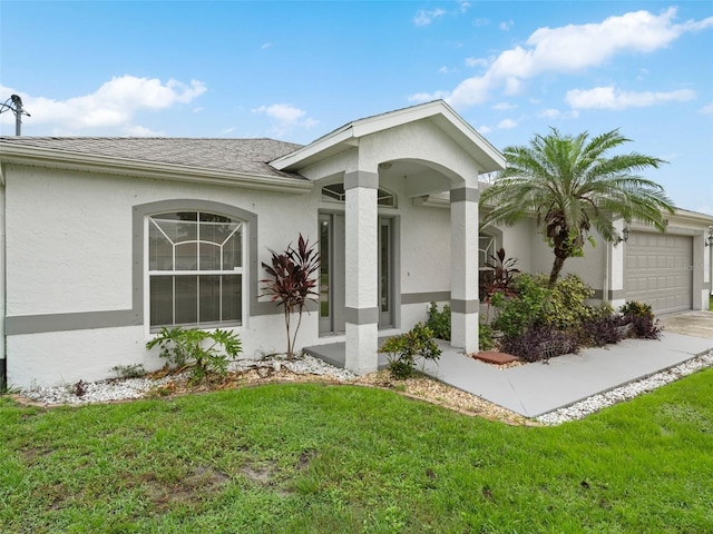 view of front of house with a garage and a front lawn