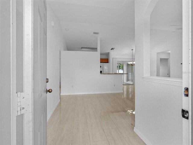 interior space with a notable chandelier and light wood-type flooring