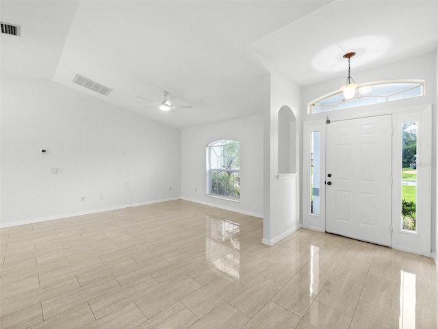 entryway featuring light tile patterned floors, vaulted ceiling, and ceiling fan